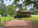 Backyard featuring a basketball court with a basketball hoop and chain-link fence surrounding it at 5141 Hiram Lithia Springs Rd, Powder Springs, GA 30127