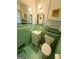 Compact bathroom with green tile, vintage fixtures, and a mirrored vanity at 5141 Hiram Lithia Springs Rd, Powder Springs, GA 30127