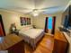 Bedroom features a bed, ceiling fan, hardwood floors, and natural light at 5141 Hiram Lithia Springs Rd, Powder Springs, GA 30127