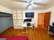 This bedroom features hardwood floors, an office desk, and built in shelves at 5141 Hiram Lithia Springs Rd, Powder Springs, GA 30127