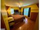 This bright bedroom features hardwood floors, a ceiling fan, and natural light from large windows at 5141 Hiram Lithia Springs Rd, Powder Springs, GA 30127