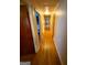 Long hallway showcasing hardwood floors and access to multiple rooms at 5141 Hiram Lithia Springs Rd, Powder Springs, GA 30127
