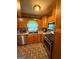 Well-lit kitchen features stainless steel appliances, wooden cabinets, and decorative tile backsplash at 5141 Hiram Lithia Springs Rd, Powder Springs, GA 30127