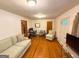 Cozy living room with hardwood floors, a comfortable sofa, and a dedicated workspace at 5141 Hiram Lithia Springs Rd, Powder Springs, GA 30127