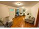 Inviting living room with hardwood floors, comfortable seating, and natural light from large windows at 5141 Hiram Lithia Springs Rd, Powder Springs, GA 30127