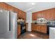 Well-lit kitchen with stainless steel appliances and classic wood cabinetry at 120 Greenview Ter, Mcdonough, GA 30253