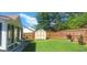 Picturesque backyard with a storage shed, privacy fence, and a covered patio area at 7314 Basalt Dr, Union City, GA 30291