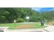 Outdoor basketball court featuring well-maintained court, surrounded by green lawns and mature trees at 7314 Basalt Dr, Union City, GA 30291