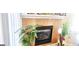 Beautiful fireplace with decorative plants sitting in front of a bright window at 7314 Basalt Dr, Union City, GA 30291