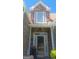 Close-up of the front door, featuring stone accents and a bright, welcoming entrance at 7314 Basalt Dr, Union City, GA 30291