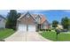 Charming brick home featuring a two-car garage and well-manicured lawn at 7314 Basalt Dr, Union City, GA 30291