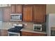 Kitchen featuring stainless steel appliances, wood cabinets and neutral countertops at 7314 Basalt Dr, Union City, GA 30291