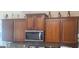 Kitchen with warm wood cabinets and stainless microwave at 7314 Basalt Dr, Union City, GA 30291