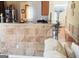 Charming kitchen featuring beautiful tile work and bar-style seating to the living room entrance at 7314 Basalt Dr, Union City, GA 30291