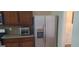 Well-equipped kitchen with stainless steel refrigerator, cabinets and tiled backsplash at 7314 Basalt Dr, Union City, GA 30291