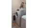 A clean and modern laundry room is equipped with a washer, dryer and storage shelves at 7314 Basalt Dr, Union City, GA 30291