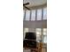 Bright living room with large windows, a ceiling fan, and a comfortable seating area at 7314 Basalt Dr, Union City, GA 30291