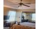 Comfortable main bedroom with a ceiling fan and lots of natural light from bright windows at 7314 Basalt Dr, Union City, GA 30291
