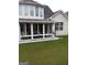 Cozy sunroom featuring bright windows, white trim, and a well-maintained lawn and landscape at 7314 Basalt Dr, Union City, GA 30291