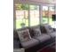 Comfortable sunroom featuring a plush sofa, throw pillows, and large windows offering views of the backyard at 7314 Basalt Dr, Union City, GA 30291