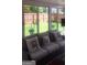 Cozy sunroom featuring large windows with view of fenced backyard and comfortable seating arrangement at 7314 Basalt Dr, Union City, GA 30291