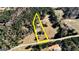 Expansive aerial view showcases a secluded property with mature trees, a private pool, and ample space at 308 Lee Thompson Rd, Moreland, GA 30259