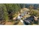 Aerial view of a house with mature trees, outbuildings, and a long driveway at 308 Lee Thompson Rd, Moreland, GA 30259
