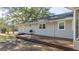 Spacious backyard featuring a wooden deck and vinyl siding at 308 Lee Thompson Rd, Moreland, GA 30259
