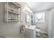 Cozy bathroom with a white vanity, decorative mirror, and shower with patterned curtain at 308 Lee Thompson Rd, Moreland, GA 30259