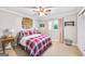 Cozy bedroom featuring a ceiling fan, neutral walls, and a decorative woven basket above the bed at 308 Lee Thompson Rd, Moreland, GA 30259