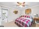 Bedroom with neutral walls, a ceiling fan, and decor, leading to an adjacent room at 308 Lee Thompson Rd, Moreland, GA 30259
