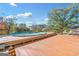 Wooden deck with a covered swimming pool and trees in the background at 308 Lee Thompson Rd, Moreland, GA 30259