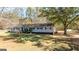 Charming single-story home featuring a well-maintained front yard and a classic ranch-style facade at 308 Lee Thompson Rd, Moreland, GA 30259
