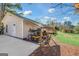 Exterior view of detached garage with covered storage space, showcasing outdoor equipment at 308 Lee Thompson Rd, Moreland, GA 30259