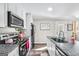 Bright kitchen with granite countertops, stainless steel appliances, and wood flooring at 308 Lee Thompson Rd, Moreland, GA 30259