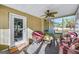 Screened porch with wicker furniture and a ceiling fan at 308 Lee Thompson Rd, Moreland, GA 30259