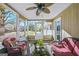 Spacious screened porch with wicker furniture, offering a relaxing outdoor living space at 308 Lee Thompson Rd, Moreland, GA 30259