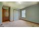 Neutral bedroom featuring carpet, double closet, window with blinds, and light blue walls at 2809 South Ola Rd, Locust Grove, GA 30248