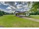 View of house with large yard featuring a covered parking structure on the side at 2809 South Ola Rd, Locust Grove, GA 30248
