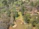 This aerial view shows a private dock and lake access with mature trees providing plenty of privacy at 2270 Emerald Dr, Jonesboro, GA 30236