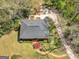 A bird's eye view of the lovely brick home shows a circle drive, mature trees, and manicured landscaping at 2270 Emerald Dr, Jonesboro, GA 30236