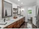 Elegant bathroom featuring a double sink vanity with marble countertop and decorative mirrors at 2270 Emerald Dr, Jonesboro, GA 30236