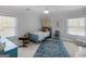 Comfortable bedroom featuring soft natural light, light blue accent wall, and plush carpet at 2270 Emerald Dr, Jonesboro, GA 30236