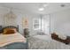 Calm bedroom featuring soft natural light, neutral wall paint, plush carpet, and vintage chest at 2270 Emerald Dr, Jonesboro, GA 30236