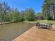 A dock on the lake features a table and chairs to enjoy a nice day by the water at 2270 Emerald Dr, Jonesboro, GA 30236