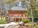 The backyard of this brick home features a patio, deck, and a view of the lovely landscaped yard at 2270 Emerald Dr, Jonesboro, GA 30236