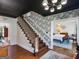 This foyer has a staircase and chandelier. A dining area can be seen from the front entry at 2270 Emerald Dr, Jonesboro, GA 30236