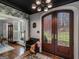 A front entry with decorative front doors, stained wood floors, and a black ceiling at 2270 Emerald Dr, Jonesboro, GA 30236