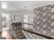 Hallway with hardwood floors, elegant lighting, and a staircase leading to the main level and bedroom at 2270 Emerald Dr, Jonesboro, GA 30236
