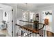 Bright hallway featuring hardwood floors, a modern chandelier, and white trim at 2270 Emerald Dr, Jonesboro, GA 30236